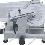 Commercial meat slicer. Gray machine with circular blade, food carriage, and thickness adjustment knob.
