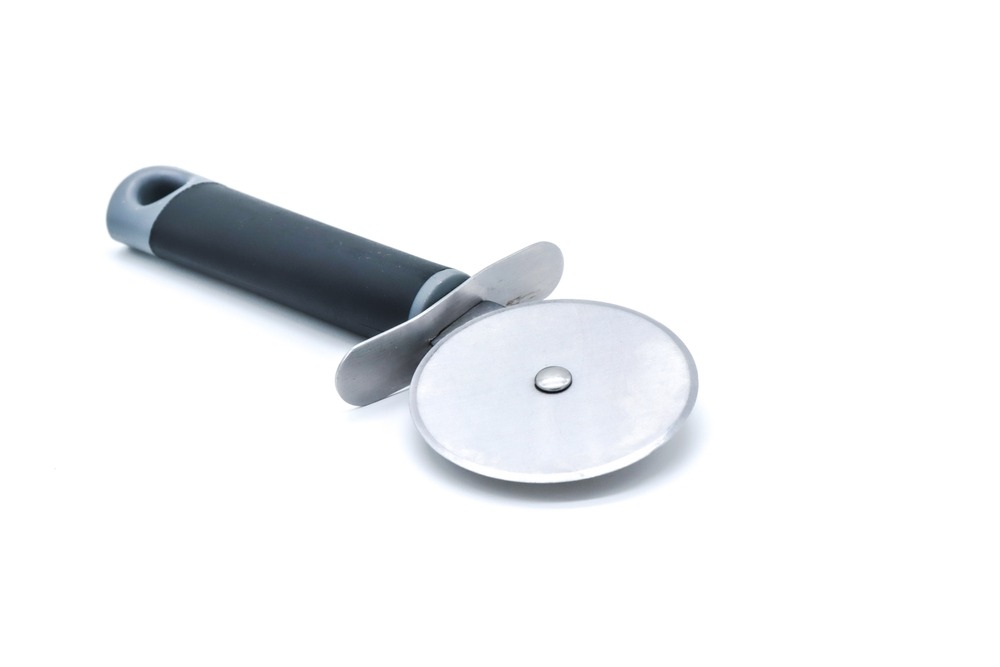 A pizza cutter with a black handle and silver blade against a white background